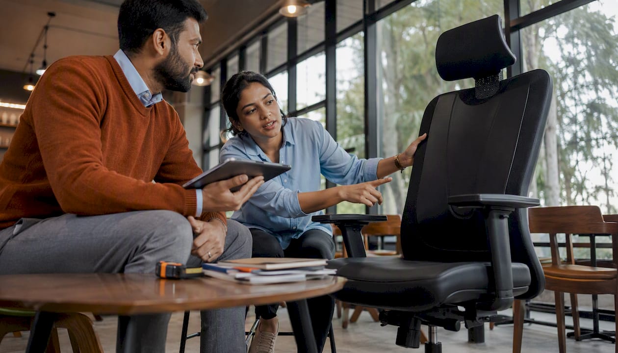 Two workers discussing heavy duty office chair