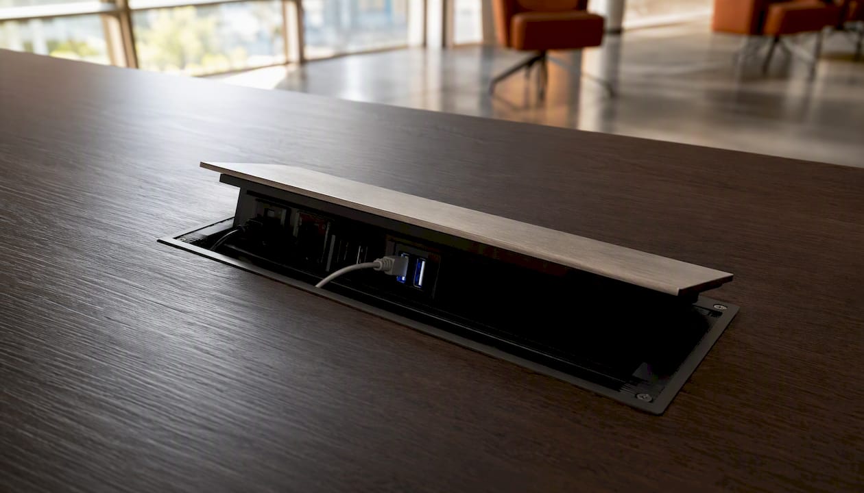Flip-top power module partially open on table