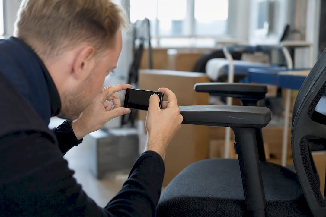 Hand photographing defect on office chair armrest