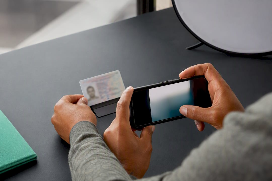 Hands photographing an identity document