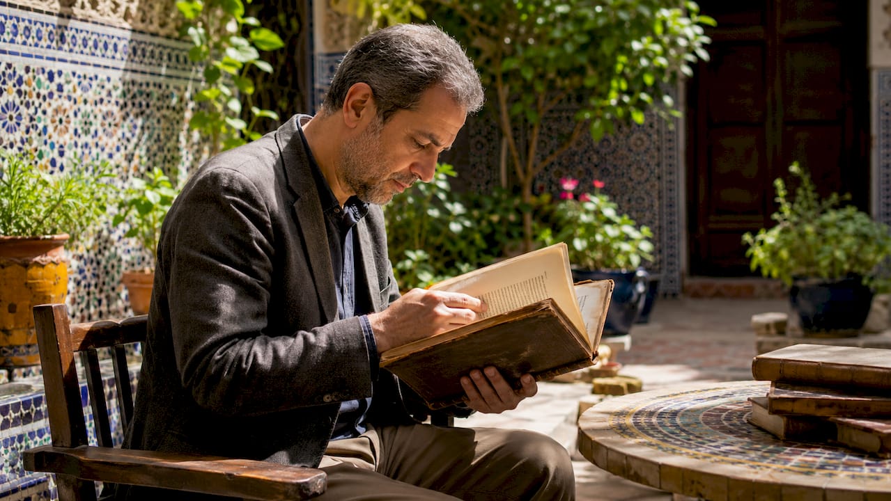 Historian reading ancient Moroccan manuscripts