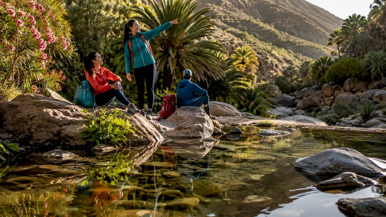 Agadir Tours: Best Day Trips and Excursions 1 Hikers resting by natural pool in Paradise Valley