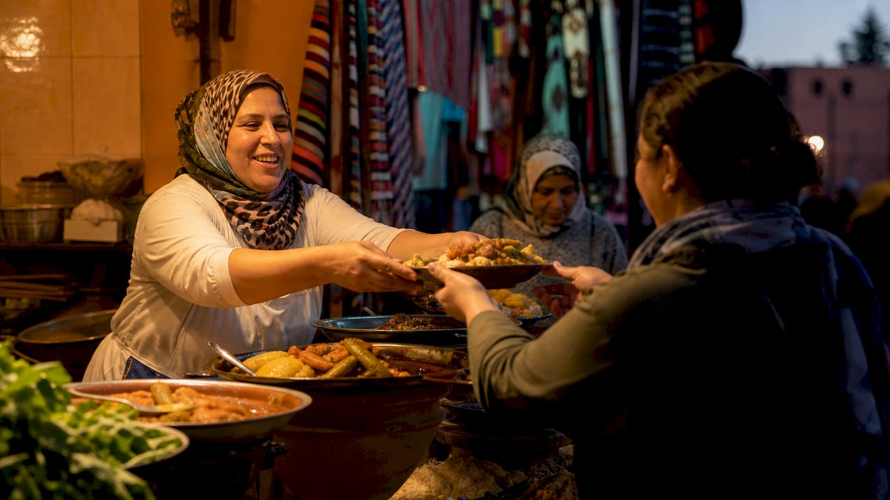 Moroccan street food vendor serving dishes