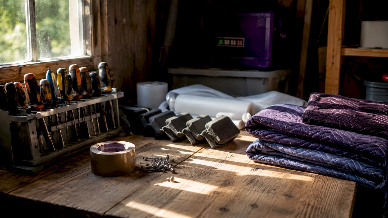 Furniture removal tools and protective gear arranged on workbench