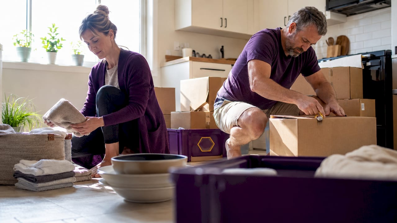 Couple packing household items for move