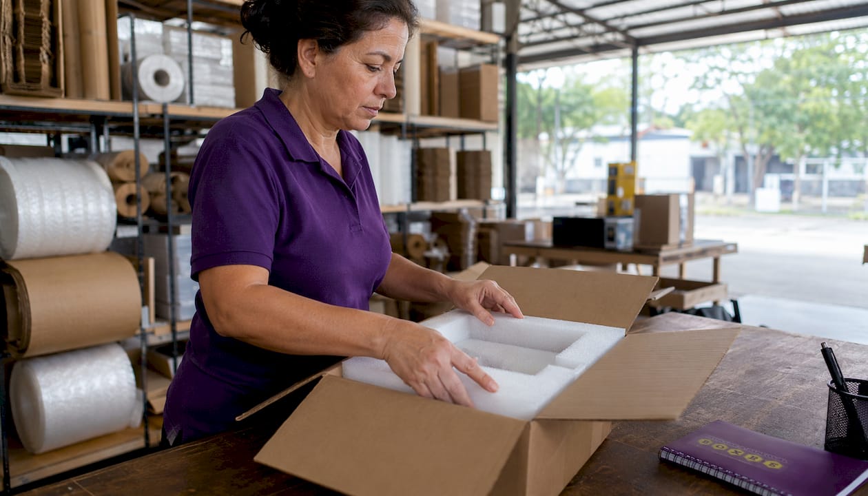 Warehouse manager preparing custom packing box