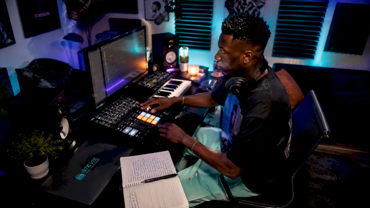 Artist adjusting controls in music recording studio
