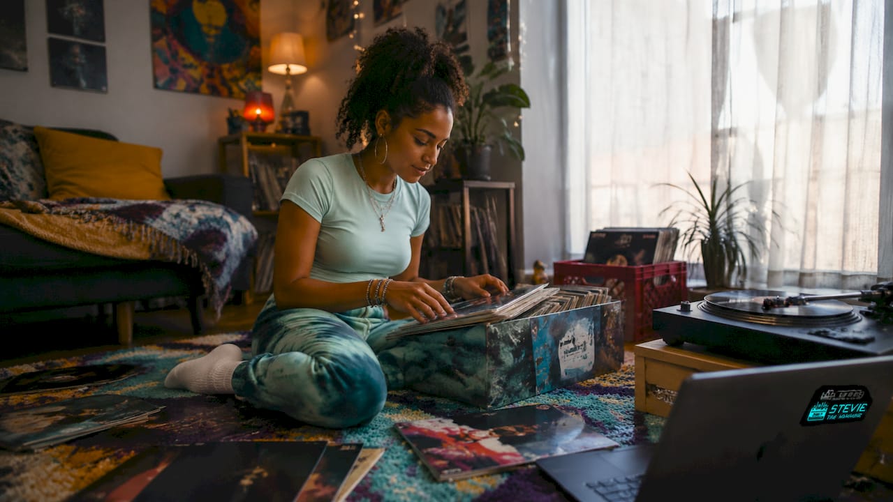 Hands browsing vinyl records in apartment