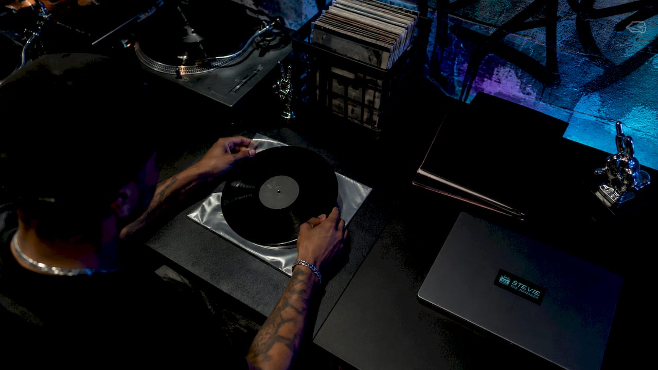 Hands managing vinyl records in loft workspace