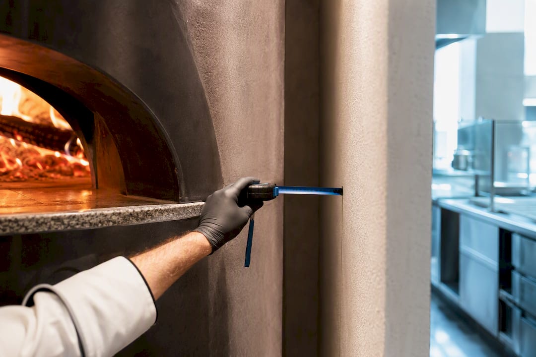 Partial commercial oven installation with measured clearances