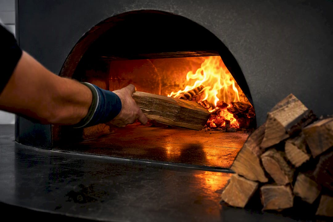 Clean fire burning inside wood-fired oven