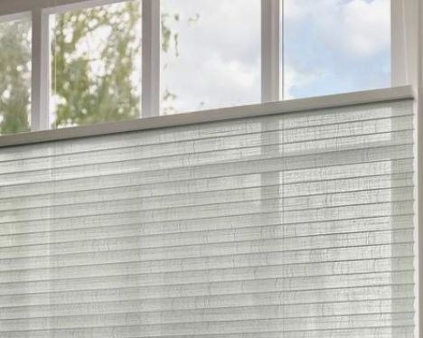 Installer showing cellular honeycomb blind structure to homeowner