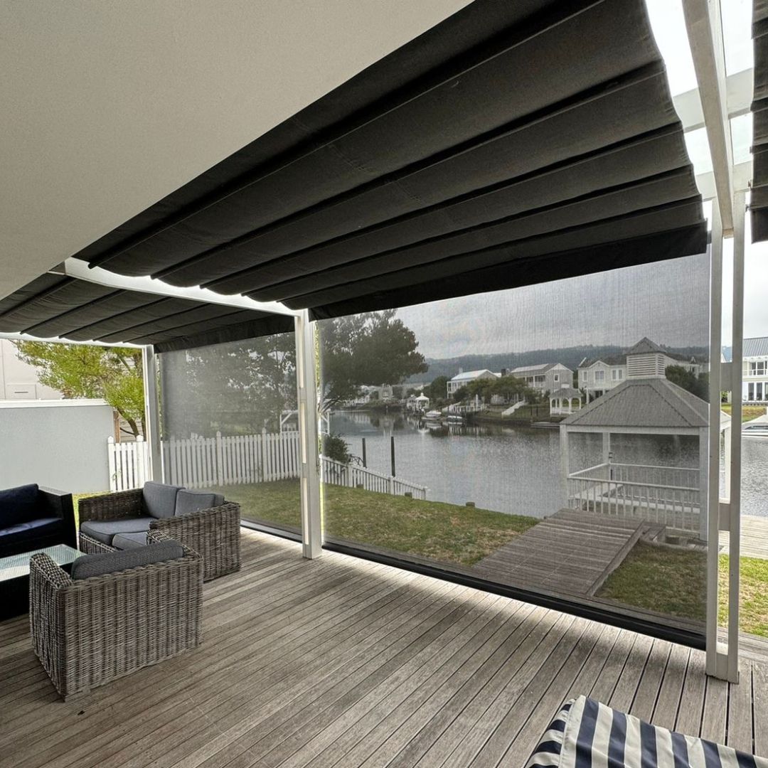Family relaxing in cool living room with exterior roller blinds for climate comfort