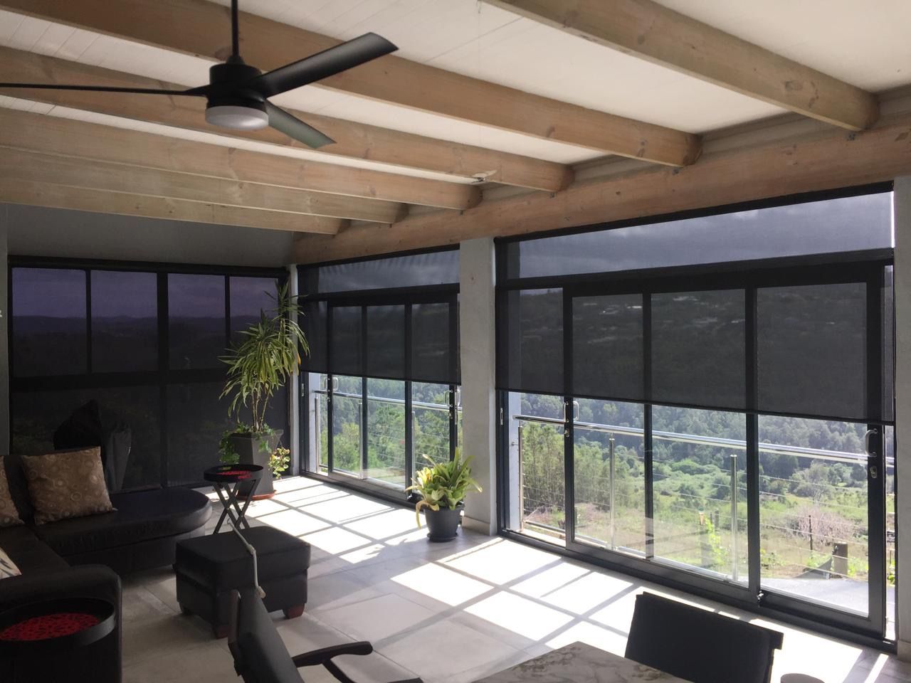 South African family reviews blind options in a sunlit living room with consultant