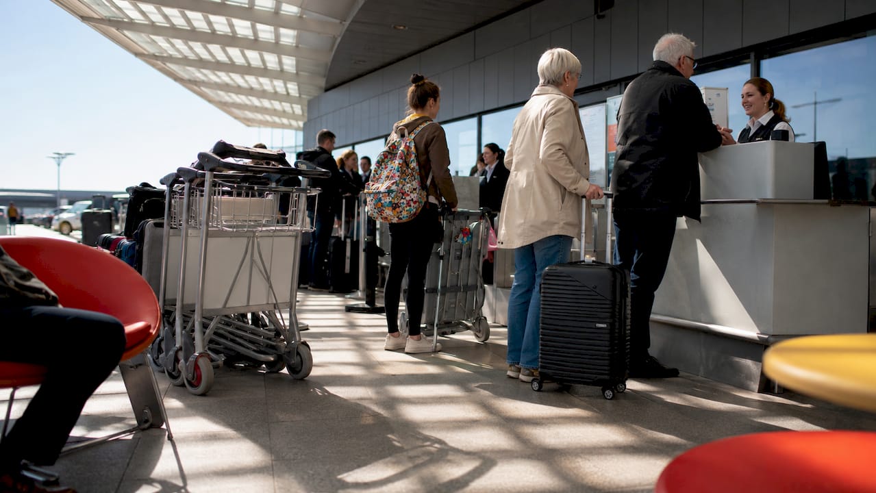 Passengers queuing at busy Keflavík Airport check-in counters