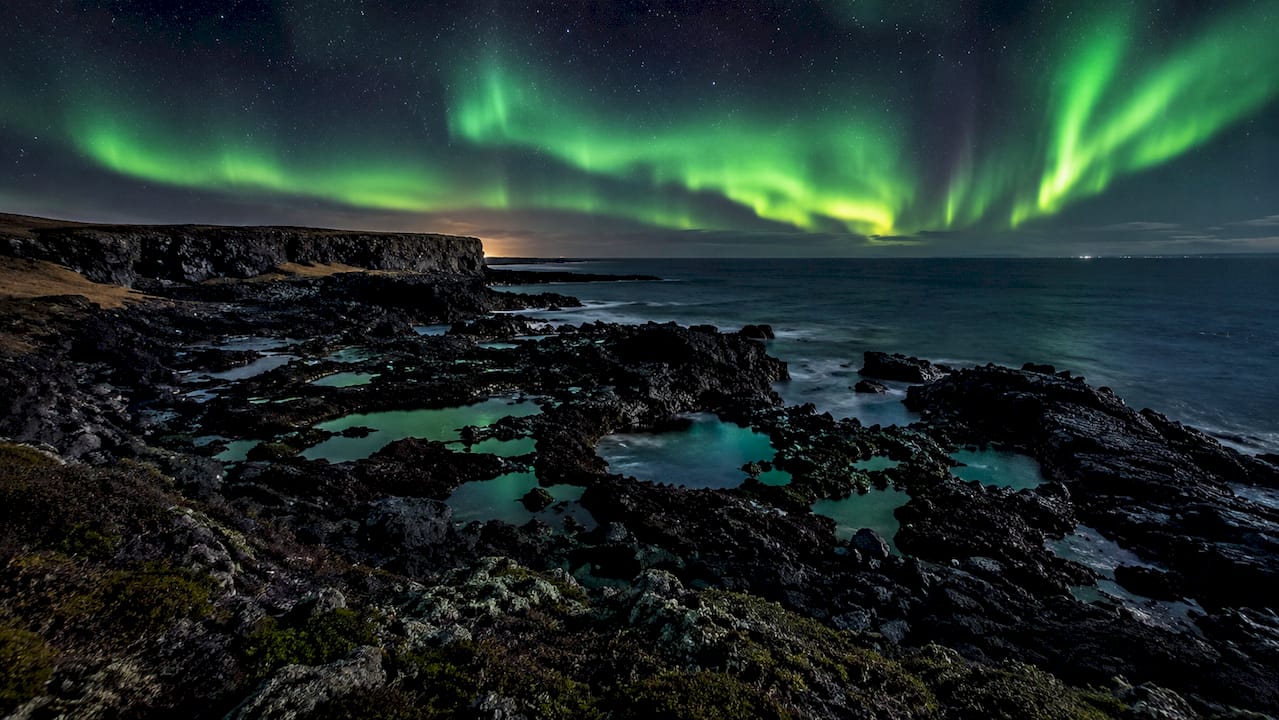 Aurora over rocky Reykjanes Peninsula landscape