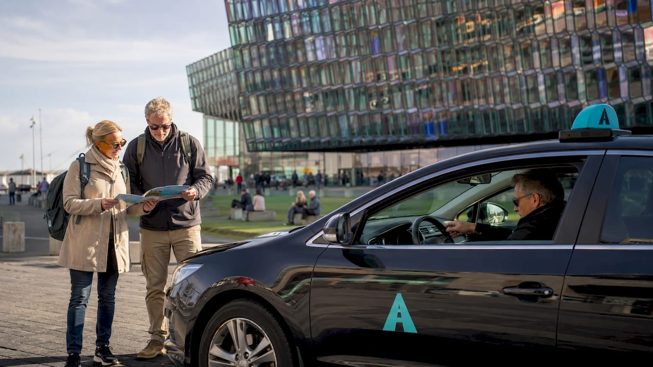 Couple preparing to enter taxi near Reykjavik cruise terminal