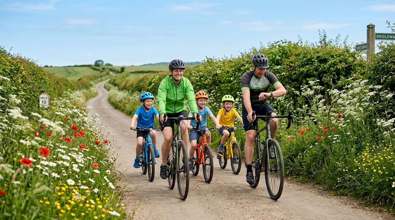 Family cycling together on suburban sidewalk