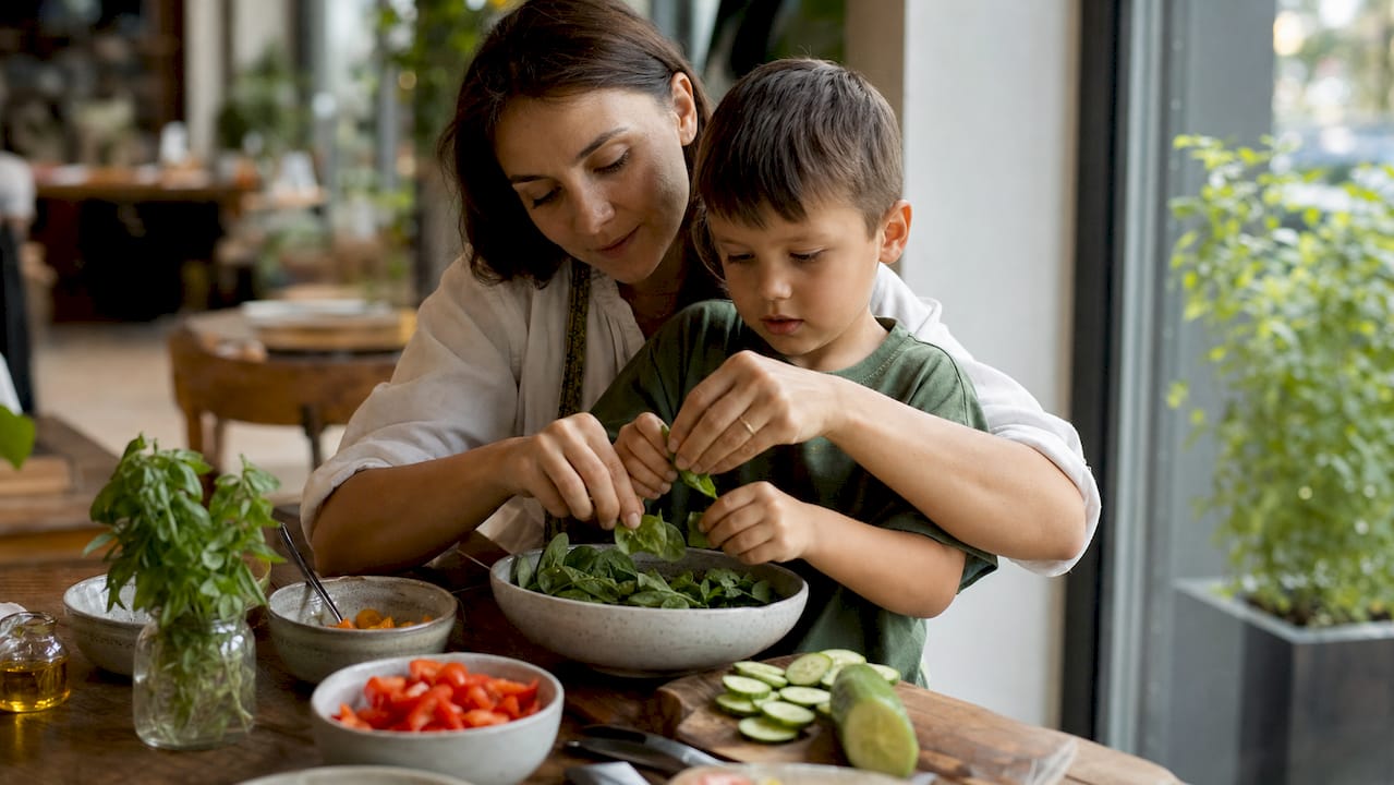Mother and child preparing healthy salad