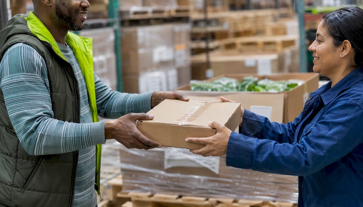 Hands exchanging organic certified product box