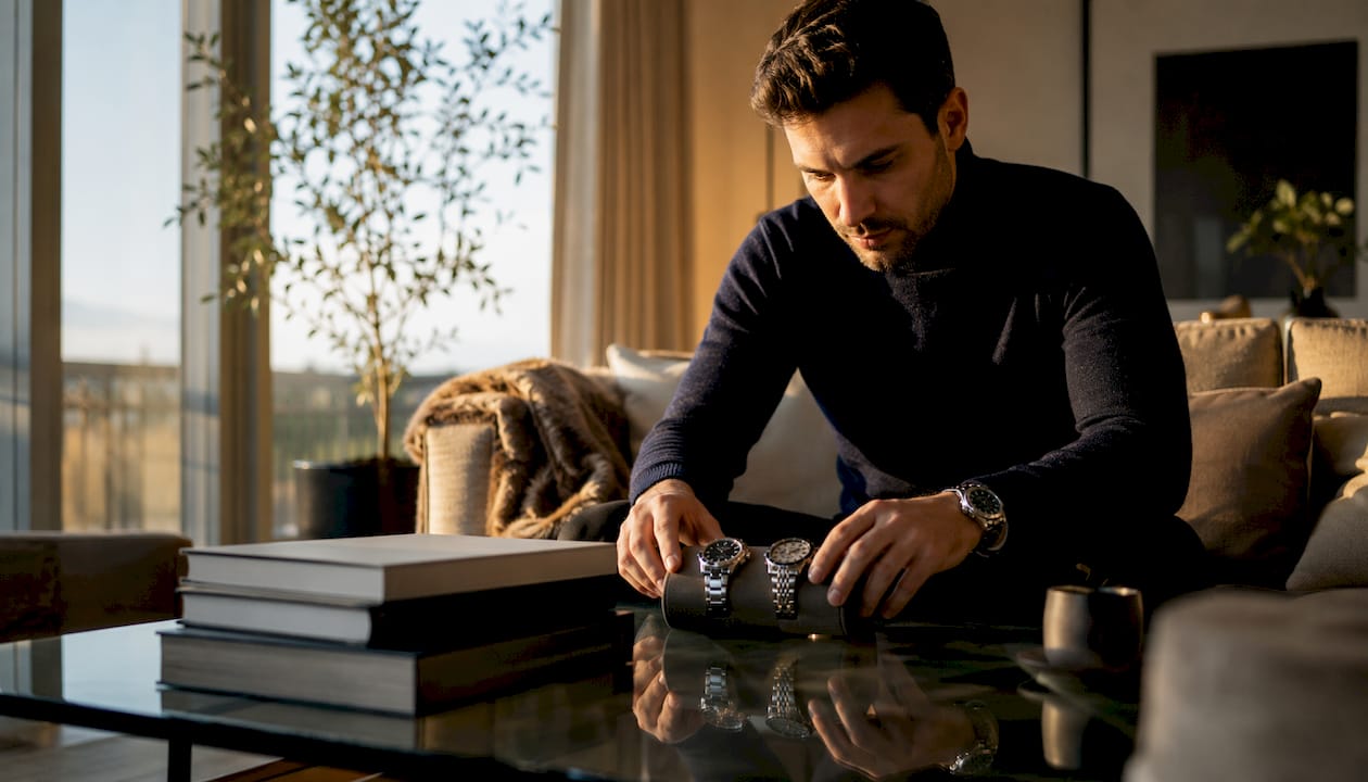 Man comparing luxury wristwatches at home