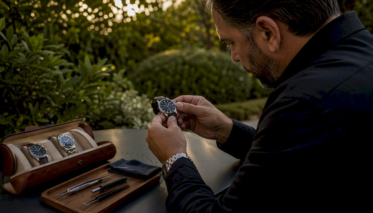 Collector inspecting luxury wristwatch at desk