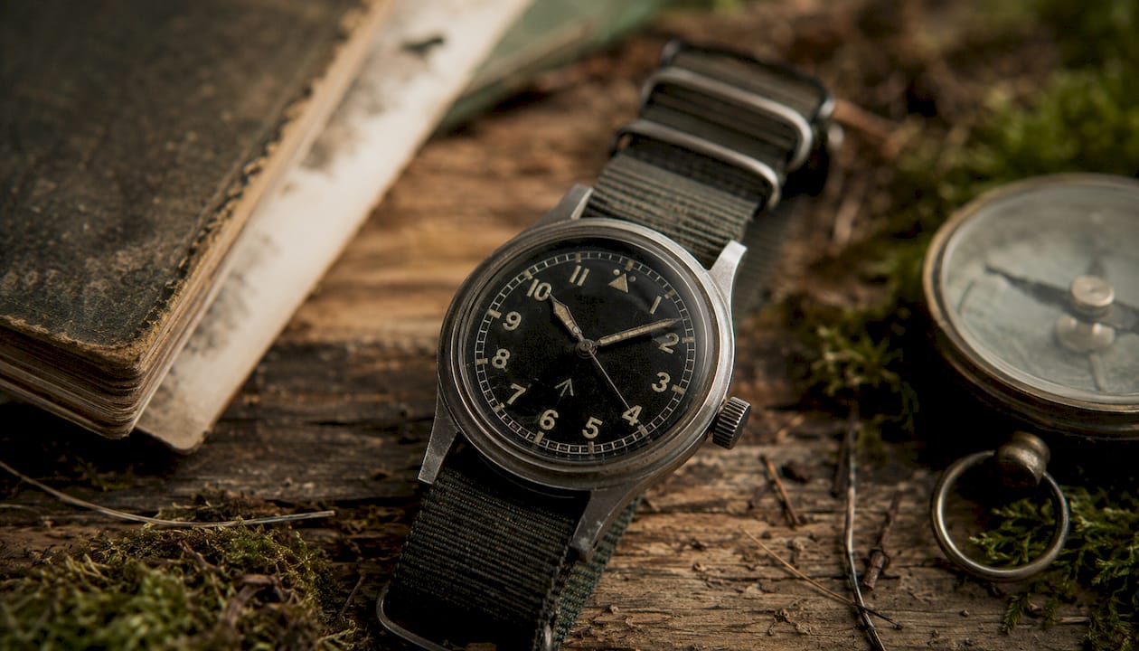 Close-up of vintage military watch on olive fabric