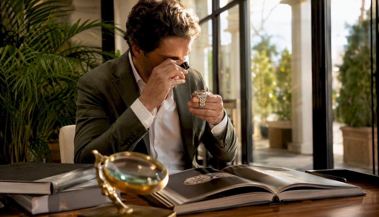 Man inspecting Rolex watch serial number