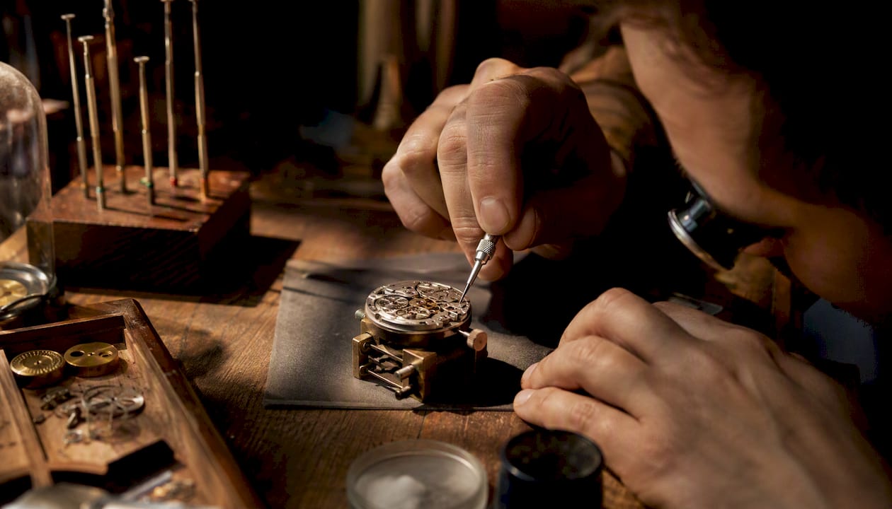 Watchmaker lubricating mechanical watch movement