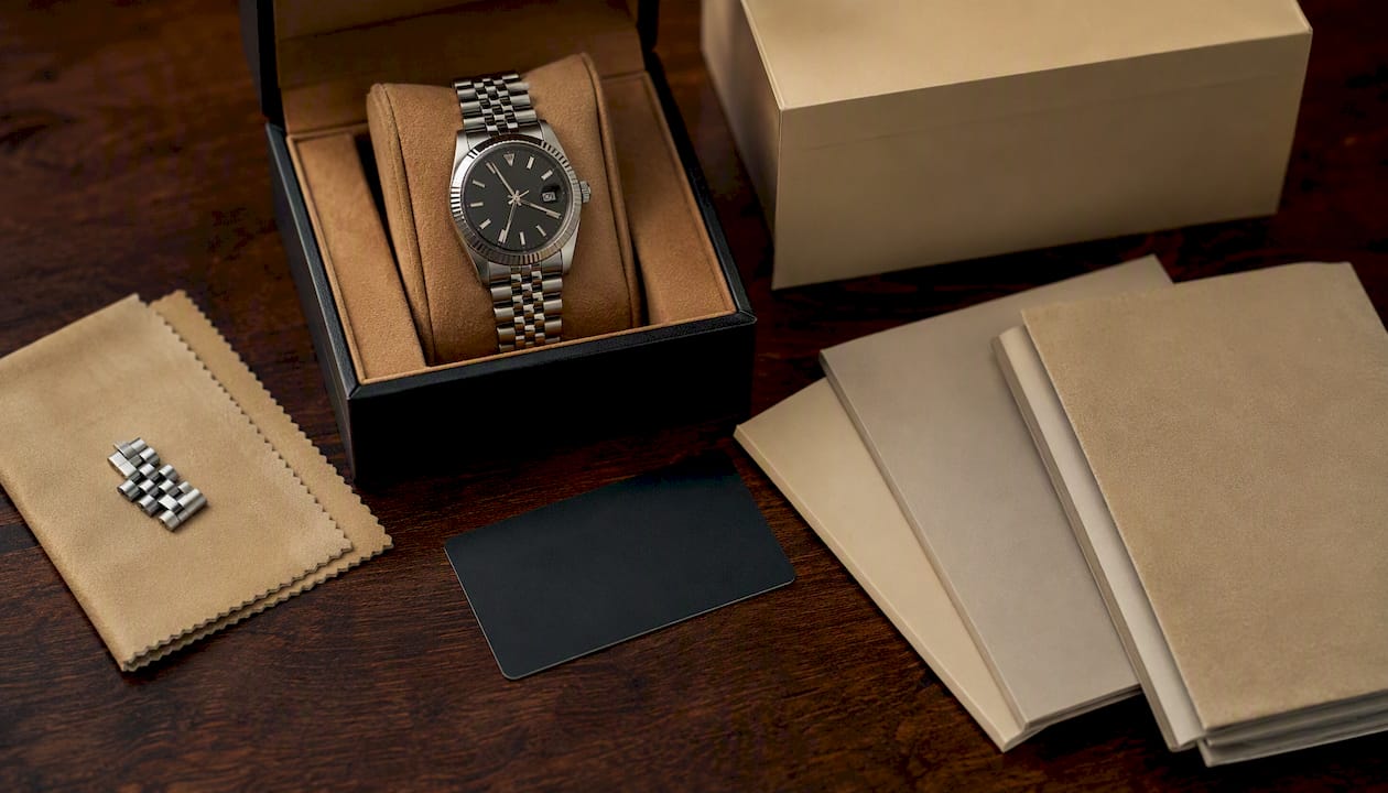 Original box, warranty card, and booklets lay on wooden surface
