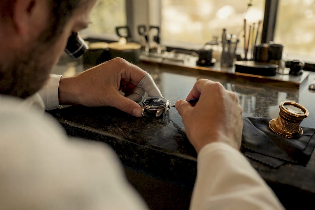 Watchmaker photographing polished watch case
