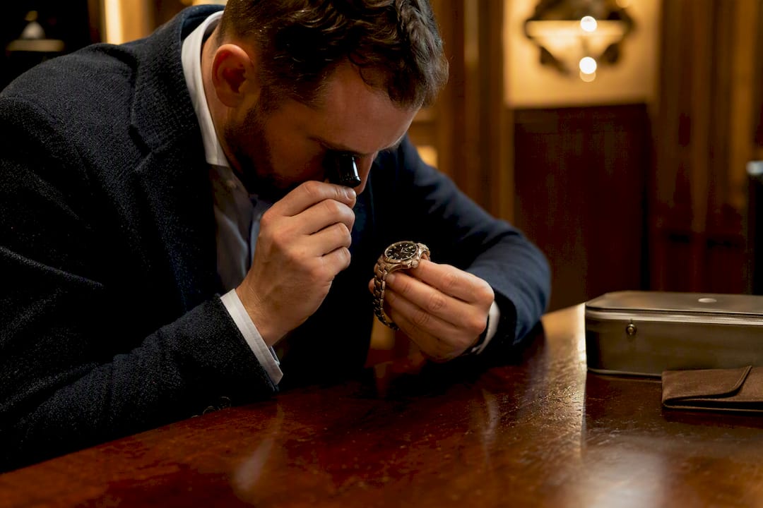 Watch expert inspecting luxury timepiece