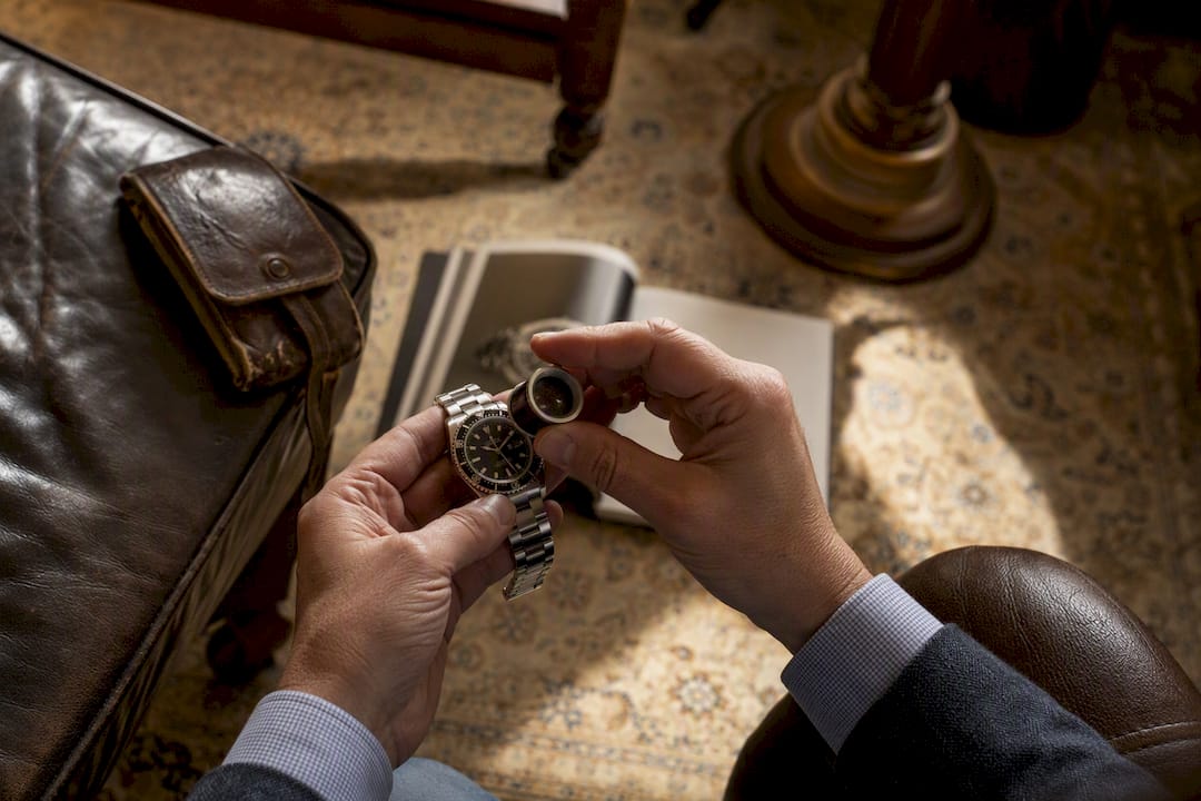 Hands examining luxury watch details