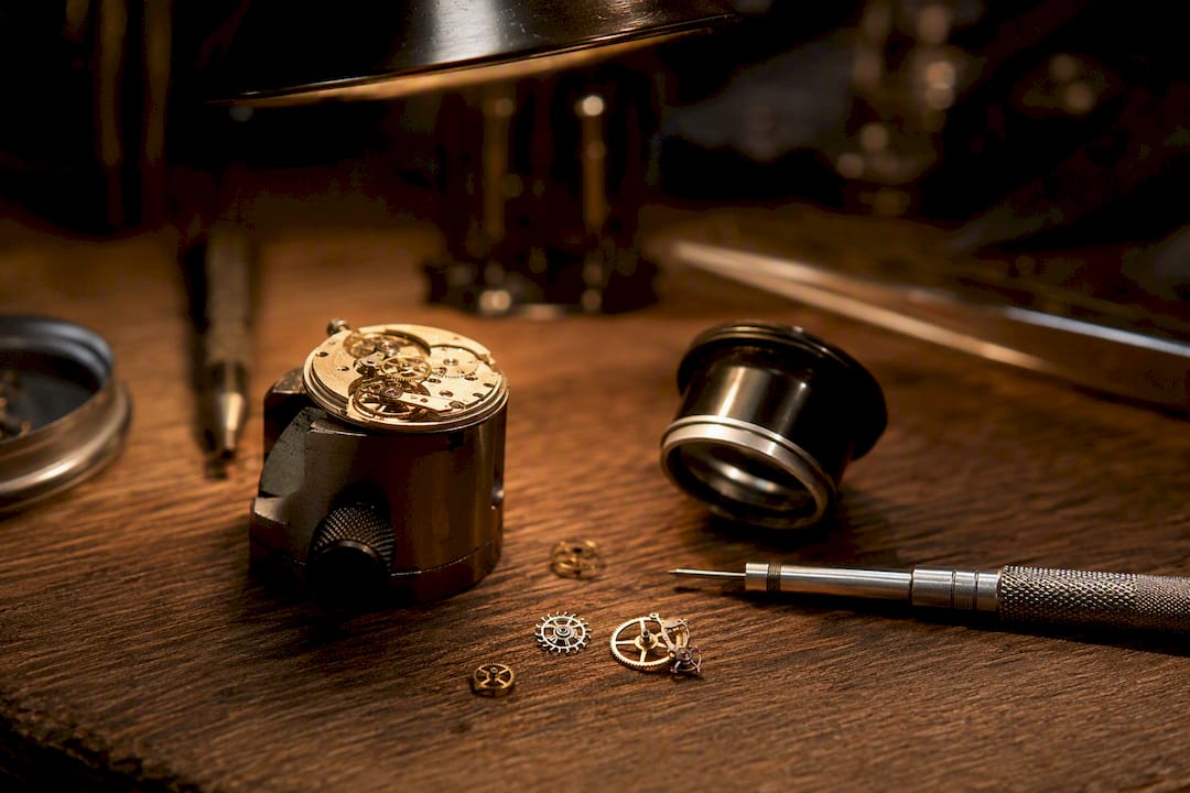 Watch servicing tools and open case back close-up