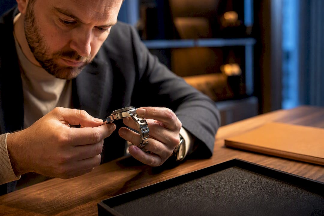 Dealer examining an anonymous luxury watch