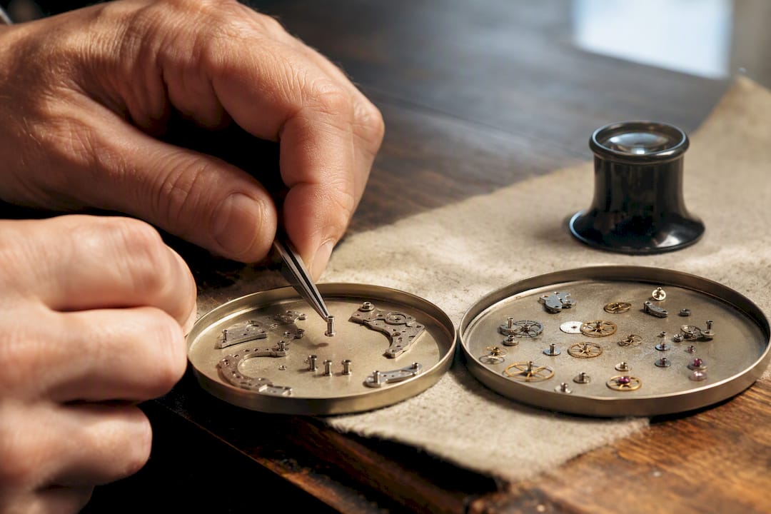 Vintage movement components being compared for restoration