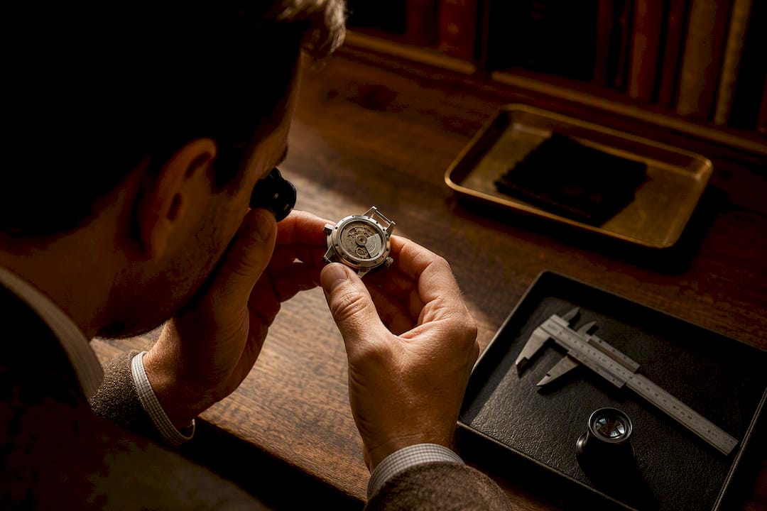 Valuer examining a luxury watch case
