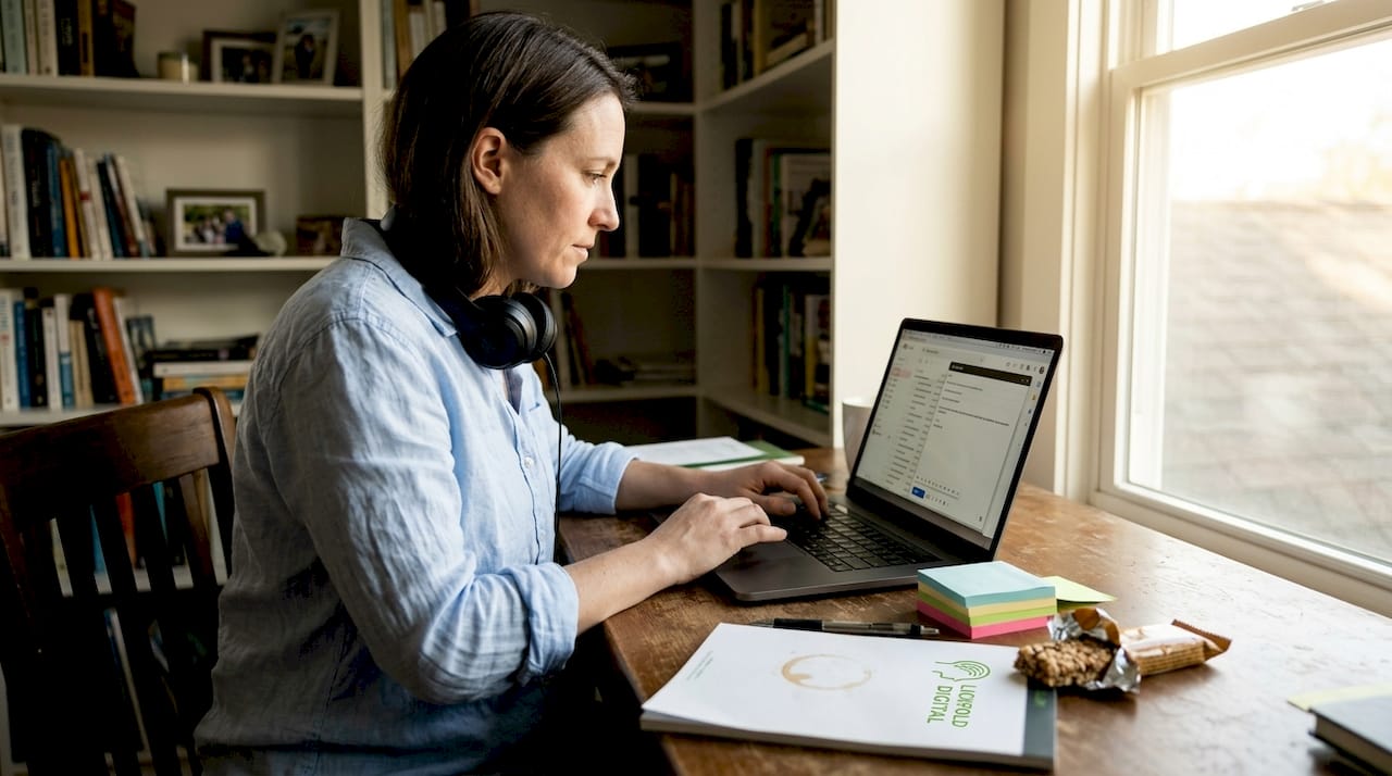 Professional managing email outreach in home office