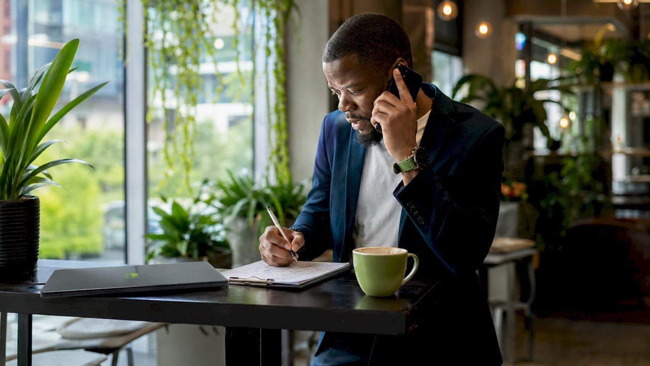Sales lead reviewing notes while on phone call