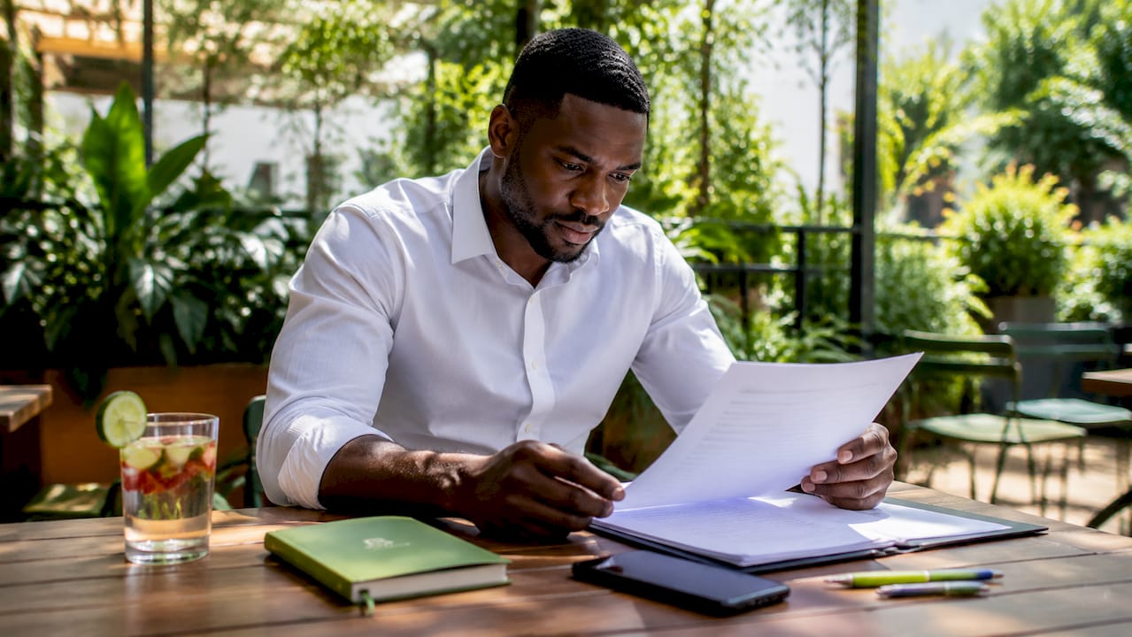 Hands reviewing cross-border business compliance papers