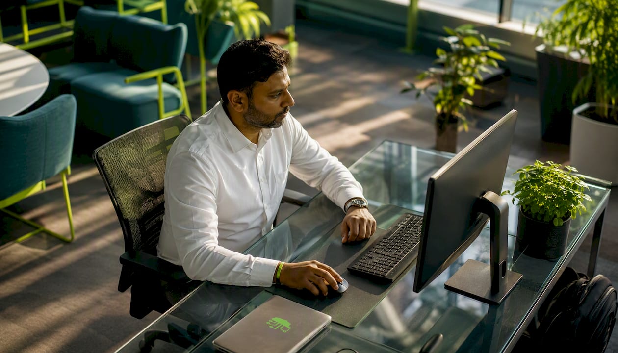 Man working with CRM software at office desk