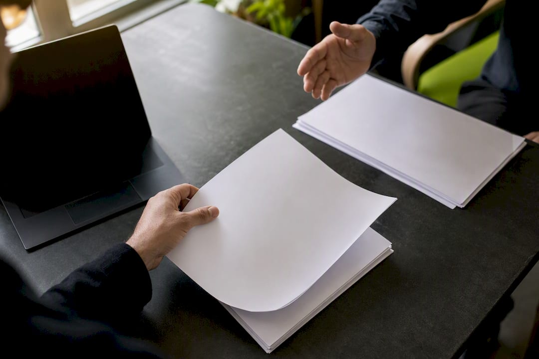 Hands reviewing sales lead quality check report