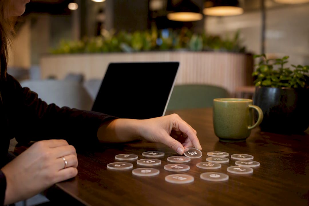 Hand arranging data tokens on desk