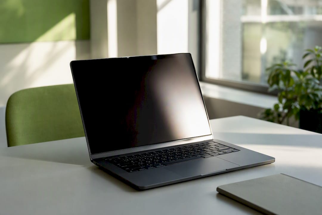 Laptop keyboard with blurred screen researching news