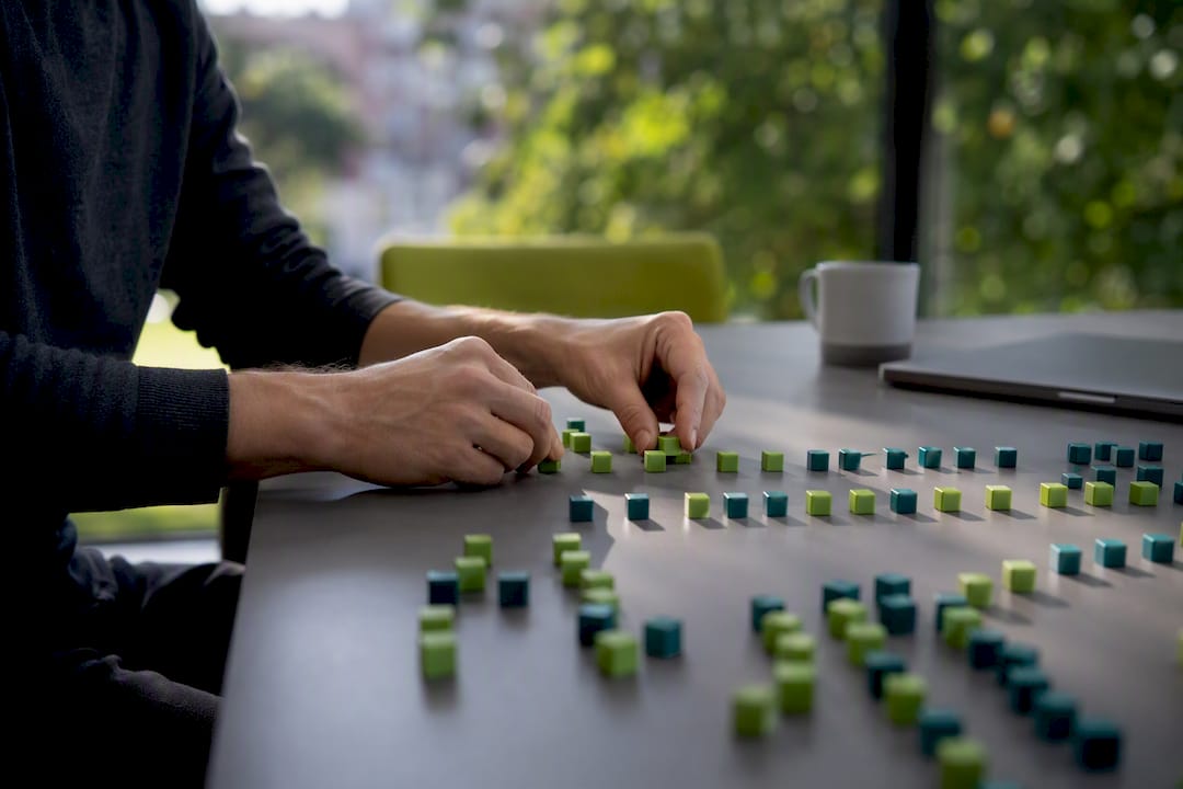 Hands arranging data tokens symbolizing AI citations
