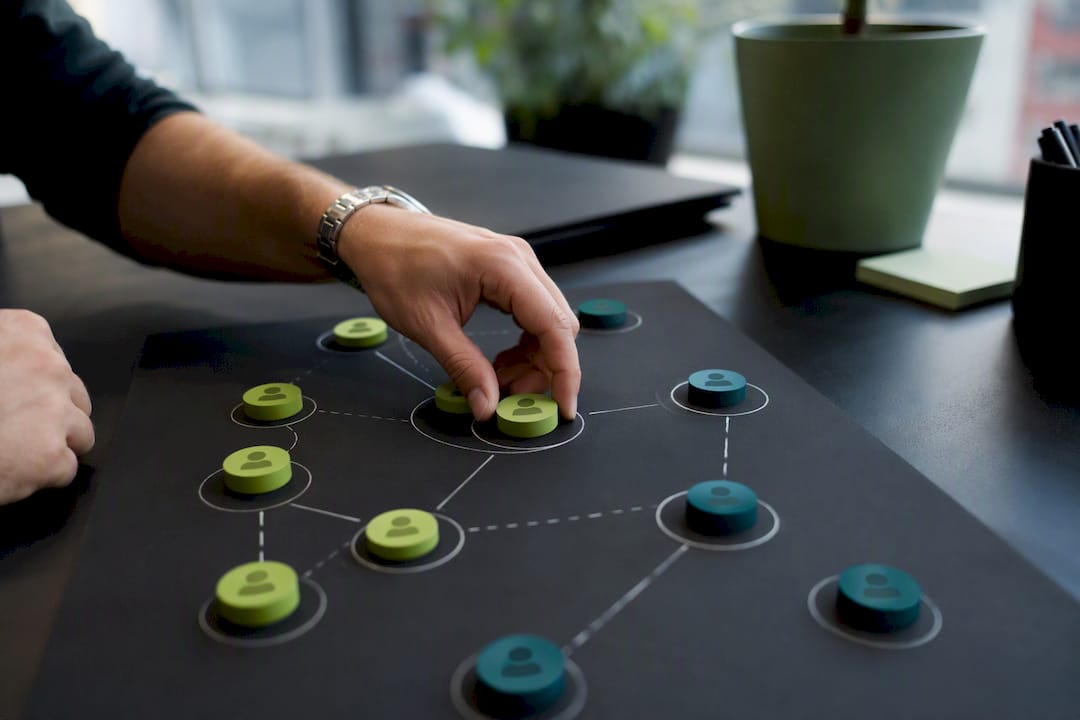Hands placing tokens representing AI market research