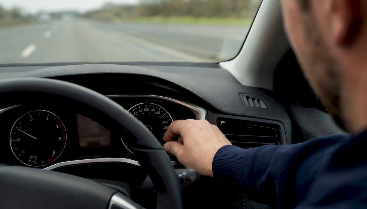 Hand adjusting car odometer mileage display