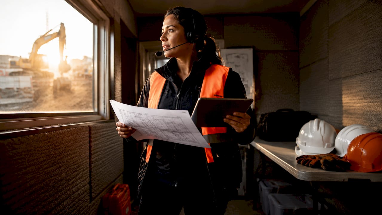 Project manager reviewing plans in site office