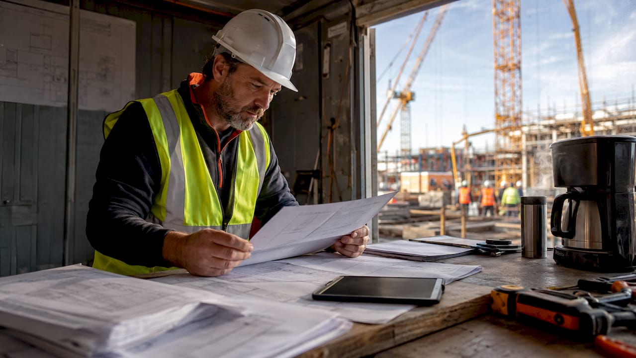 Project manager reviewing construction schedule on site