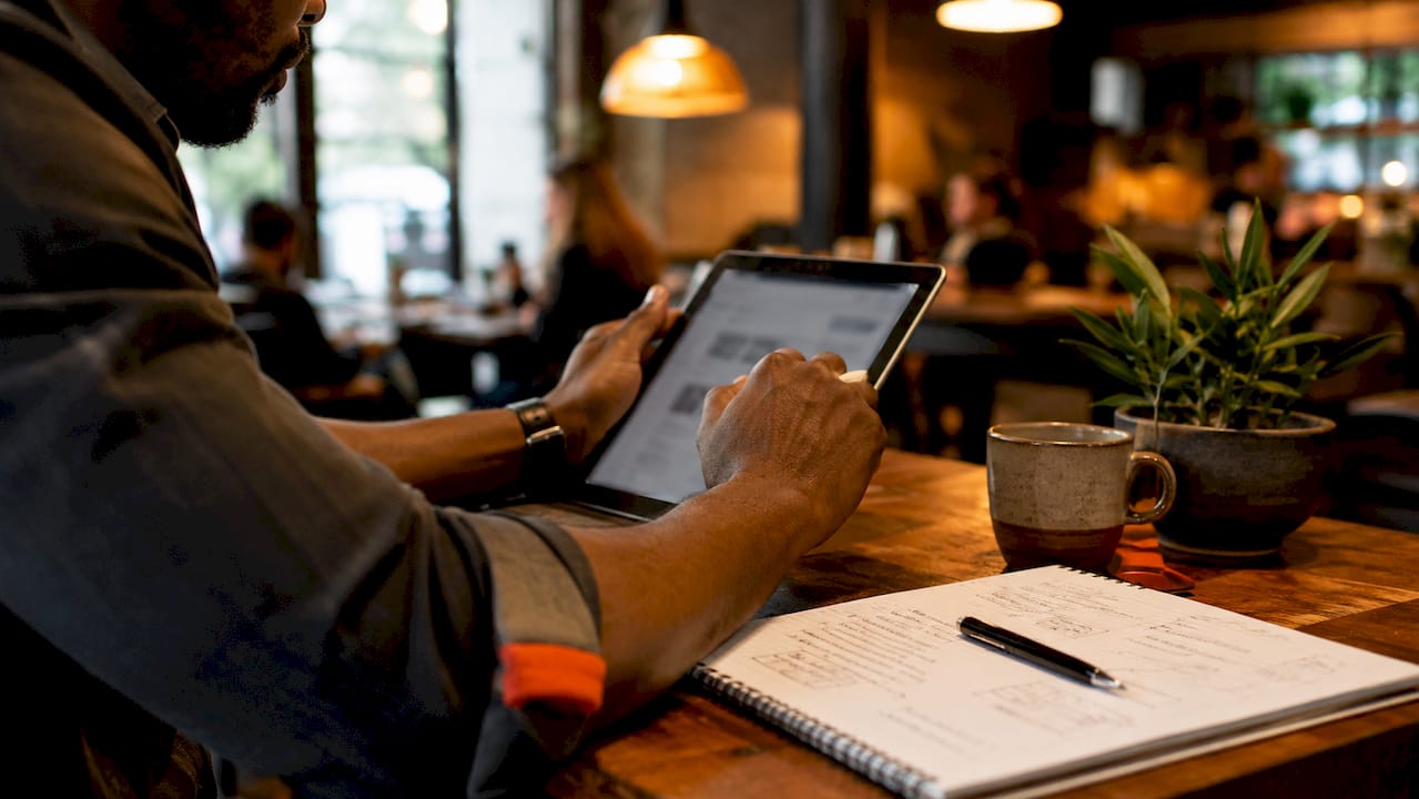 Hands using estimating software on tablet